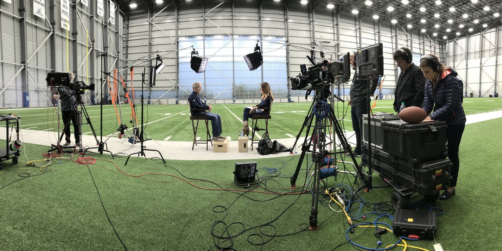Broadcast interview set with camera operators and crew
